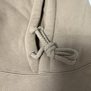 Close up of the hoodie drawcord and hood stitching